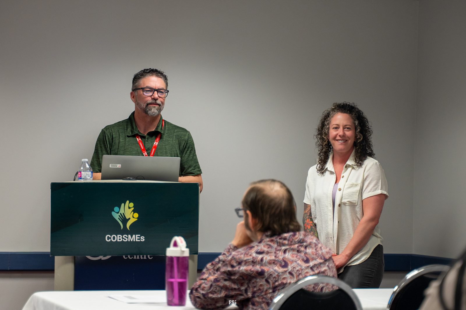 Two CoBSMEs facilitators lead the session from the branded podium in Regina