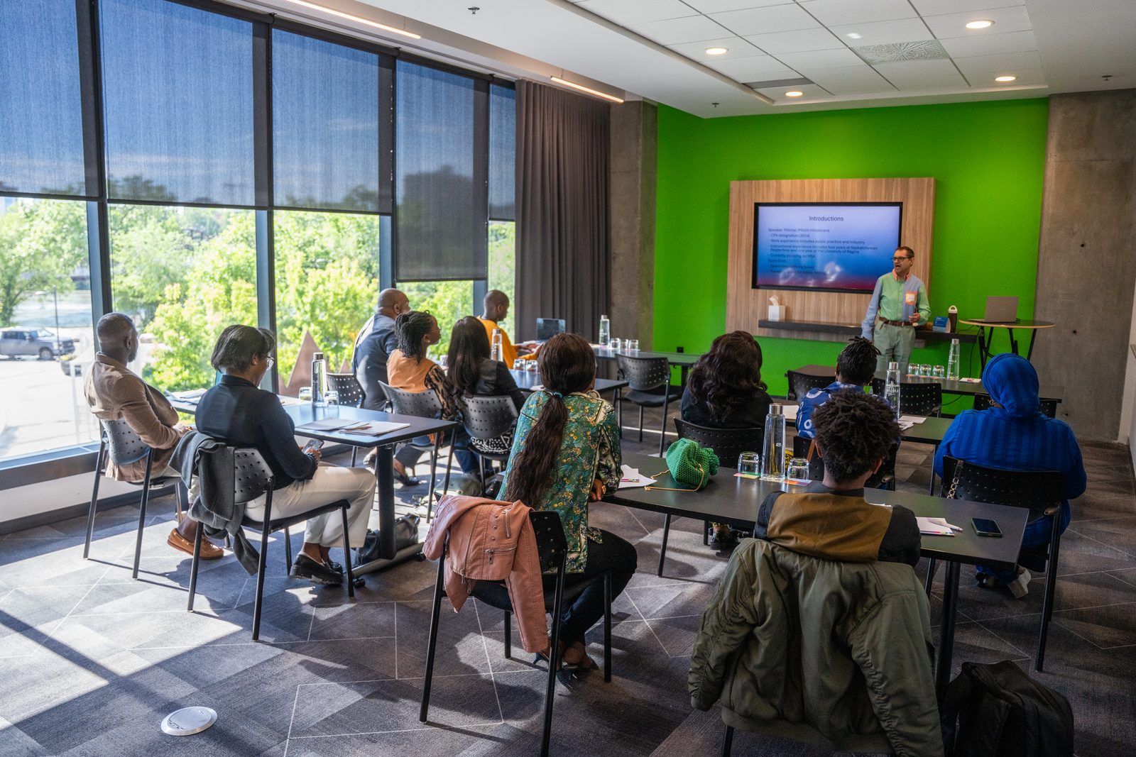 A wide view of the Saskatoon cohort room as participants gather for the session